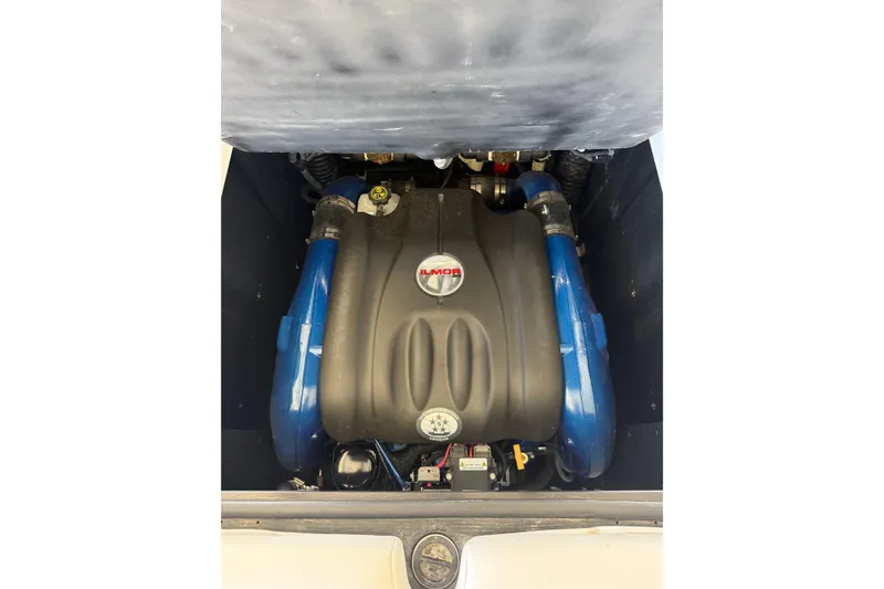 Slide: The Image of 2021 MasterCraft XStar engine compartment with Ilmor engine, featuring blue components. - 22