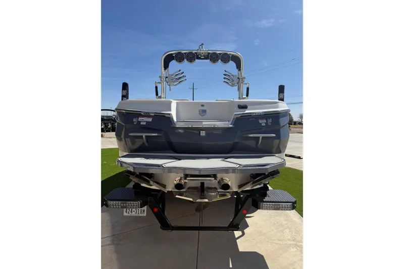 Slide: The Image of 2021 MasterCraft XStar boat rear view with wakeboard tower and swim platform. - 5