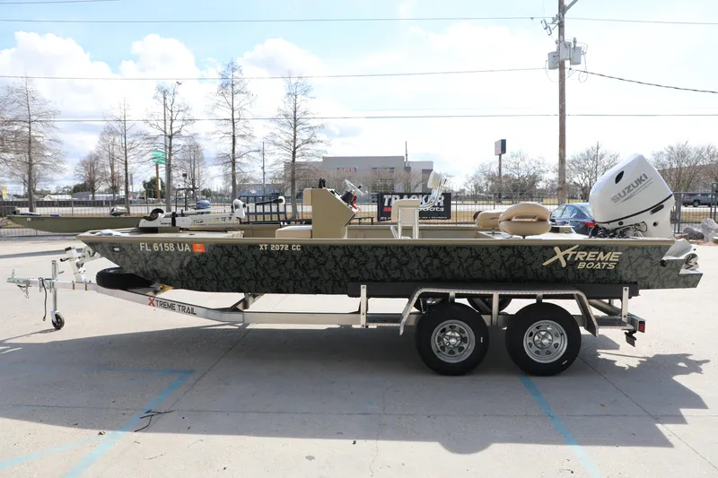 Slide: The Image of 2025 Extreme Boats 2072 CC on trailer, featuring Suzuki outboard motor, parked outdoors. - 1