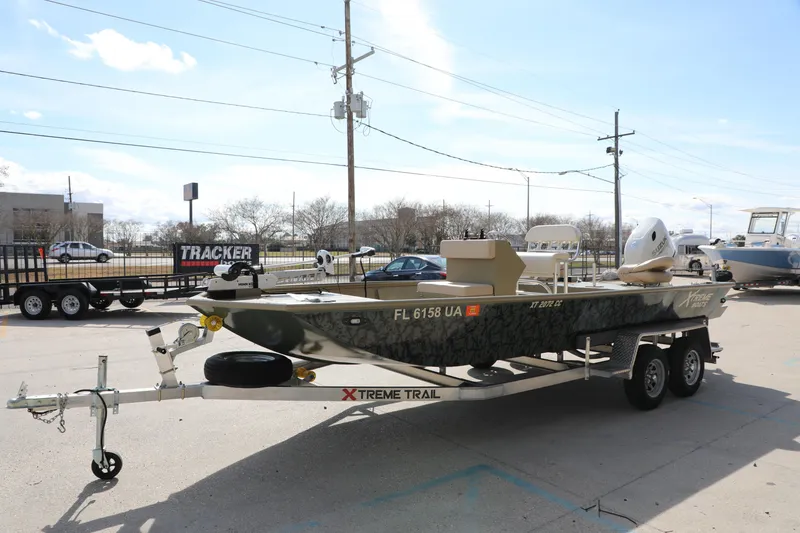 Slide: The Image of 2025 Extreme Boats 2072 CC on trailer, parked outdoors under clear sky. - 2