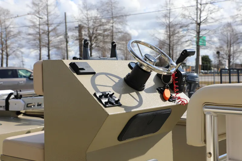 Slide: The Image of 2025 Extreme Boats 2072 CC console with steering wheel and controls, outdoors. - 3