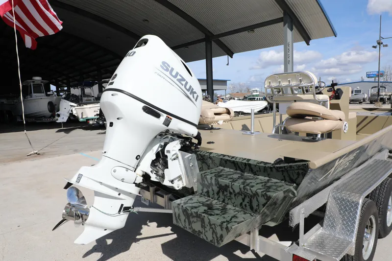 Slide: The Image of 2025 Extreme Boats 2072 CC with Suzuki outboard motor on trailer at dealership. - 5