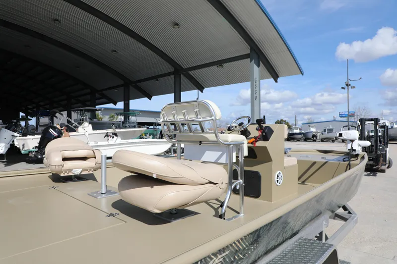 Slide: The Image of 2025 Extreme Boats 2072 CC with beige seating, displayed outdoors under a canopy. - 6