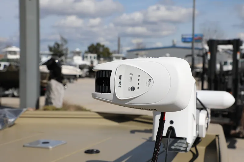 Slide: The Image of 2025 Extreme Boats 2072 CC with Minn Kota Riptide motor in a marina setting. - 7