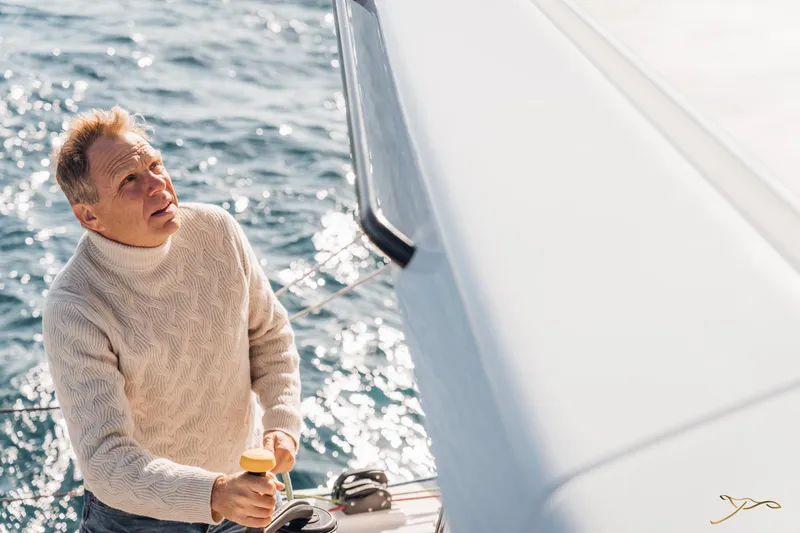 Slide: The Image of Man sailing on Nautitech 44 Open yacht, 2025 model, in sunny ocean waters. - 21