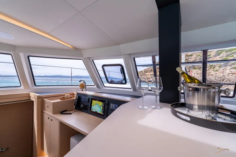 Slide: The Image of Luxurious interior of 2025 Nautitech 44 Open yacht with panoramic windows and wine setup. - 31