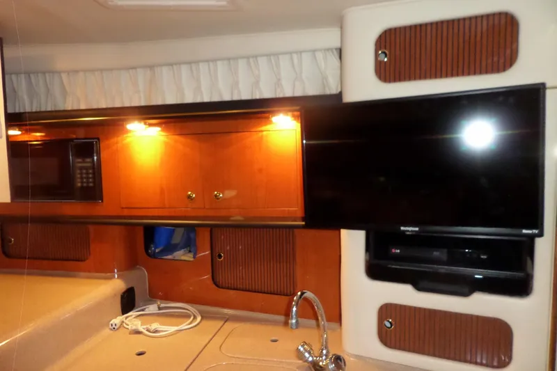 Slide: The Image of Interior of 2001 Sea Ray 340 Sundancer with TV, microwave, and wooden cabinets. - 10