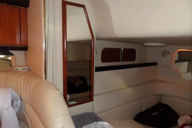 Slide: The Image of Interior of 2001 Sea Ray 340 Sundancer with beige seating and wooden accents. - 12