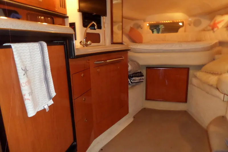 Slide: The Image of Interior of 2001 Sea Ray 340 Sundancer yacht with cozy cabin and kitchenette. - 18