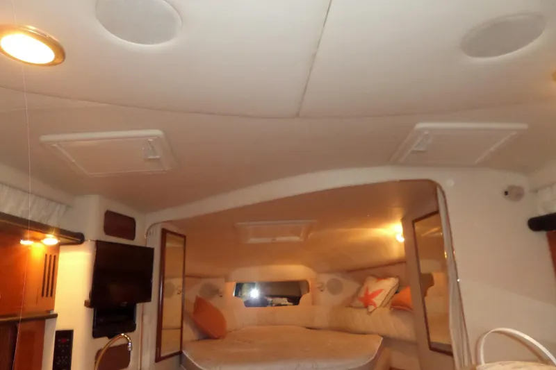 Slide: The Image of Interior cabin of 2001 Sea Ray 340 Sundancer yacht, featuring cozy sleeping area. - 19
