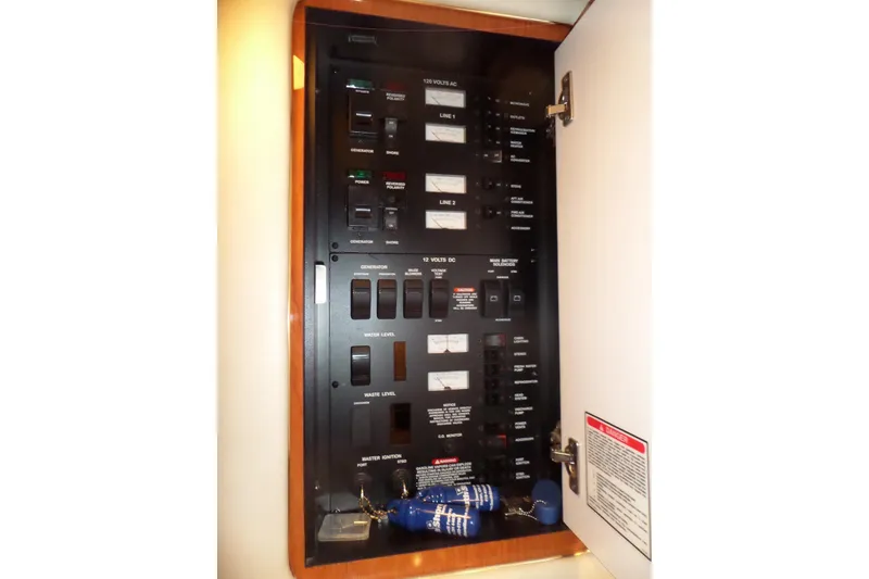 Slide: The Image of Electrical control panel inside 2001 Sea Ray 340 Sundancer boat, featuring switches and indicators. - 21
