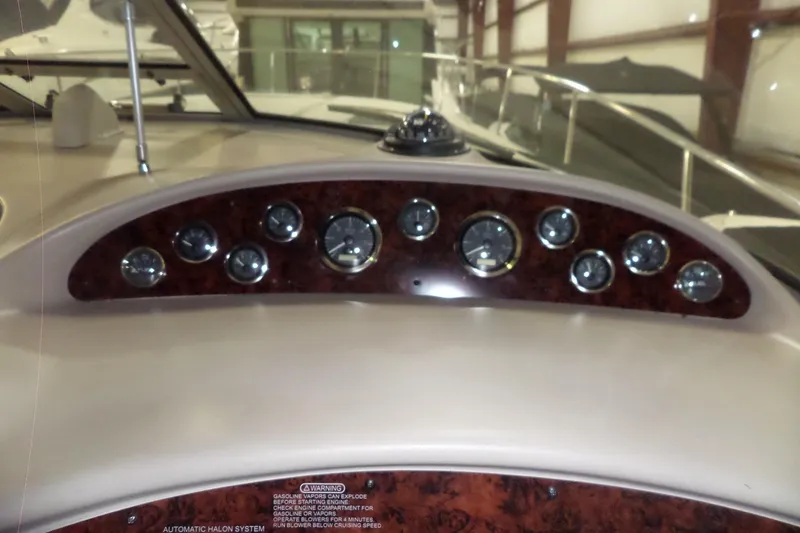 Slide: The Image of Dashboard of a 2001 Sea Ray 340 Sundancer boat with multiple gauges. - 22