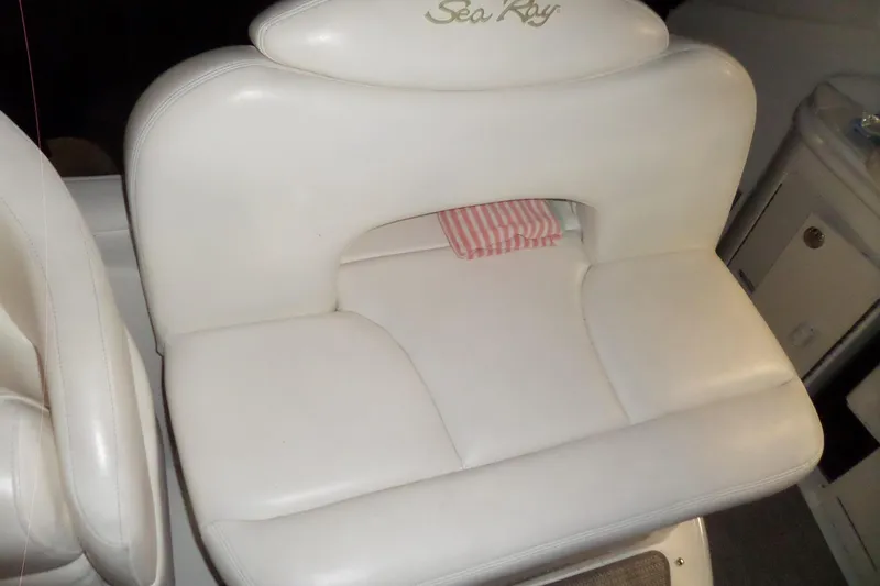 Slide: The Image of White leather seat on 2001 Sea Ray 340 Sundancer boat, featuring embroidered logo. - 29