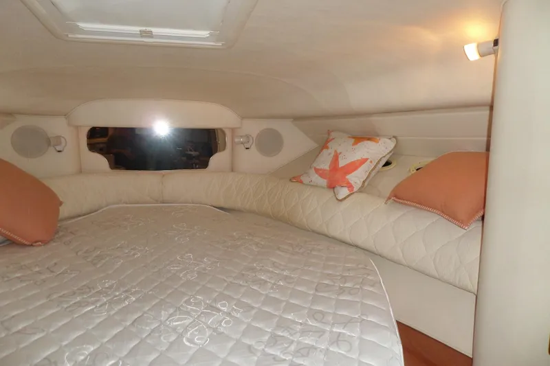 Slide: The Image of Cozy cabin interior of 2001 Sea Ray 340 Sundancer with plush bedding and soft lighting. - 3