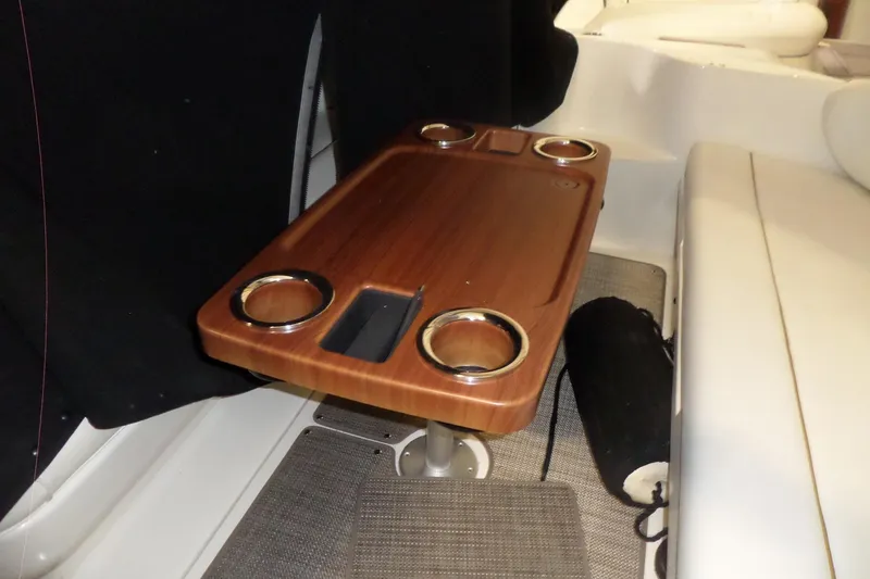 Slide: The Image of 2001 Sea Ray 340 Sundancer interior with wooden table and cup holders. - 33