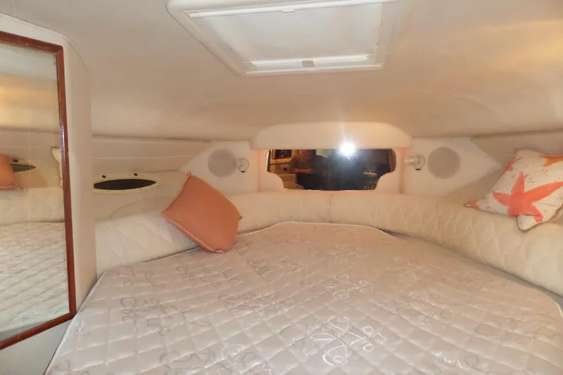 Slide: The Image of Interior cabin of 2001 Sea Ray 340 Sundancer with cozy bedding and pillows. - 4