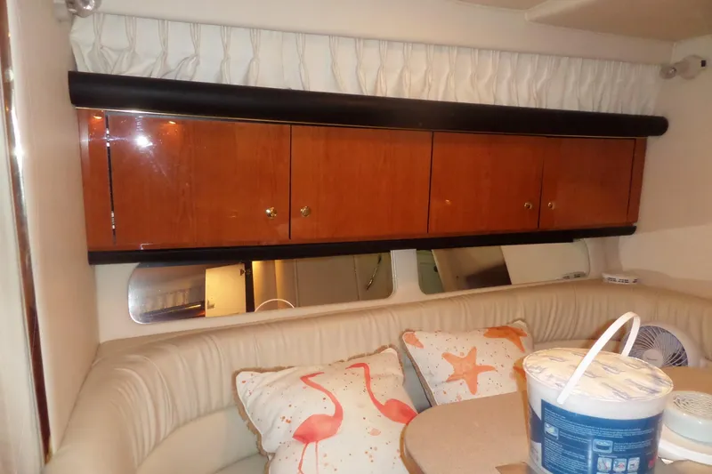 Slide: The Image of Interior of 2001 Sea Ray 340 Sundancer with wooden cabinets and cushioned seating area. - 8