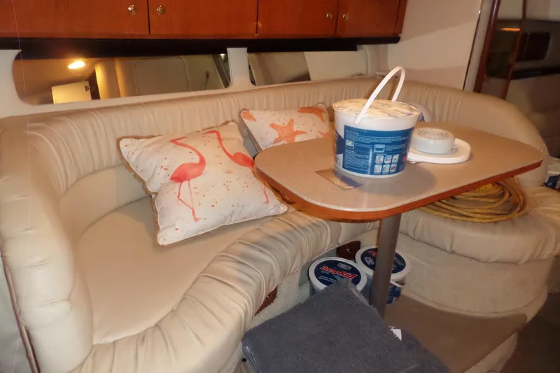 Slide: The Image of Interior of 2001 Sea Ray 340 Sundancer with cozy seating and decorative pillows. - 9