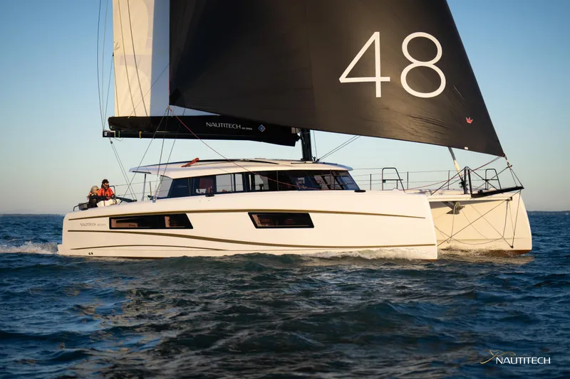 Slide: The Image of 2025 Nautitech 48 Open catamaran sailing on the ocean. - 2