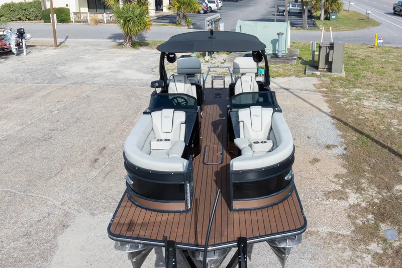 Slide: The Image of 2024 Manitou 25 LX SRW Dual Engine pontoon boat with sleek design and spacious seating. - 13