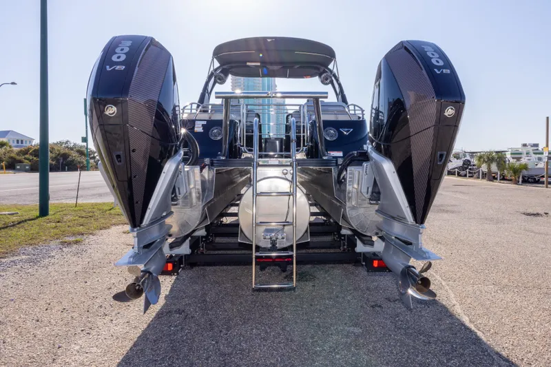 Slide: The Image of 2024 Manitou 25 LX SRW Dual Engine boat with twin 300 V8 engines, rear view. - 17