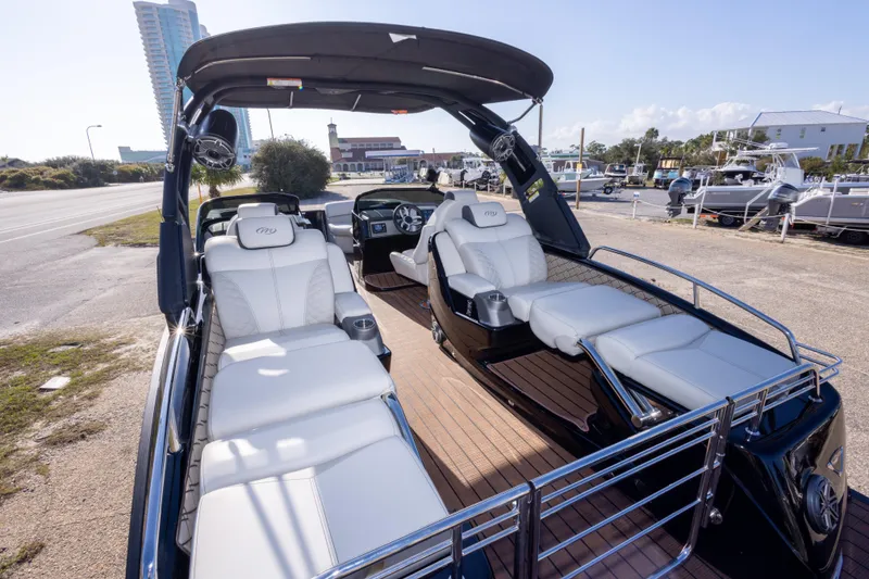 Slide: The Image of 2024 Manitou 25 LX SRW Dual Engine boat with luxurious seating and sleek design. - 22