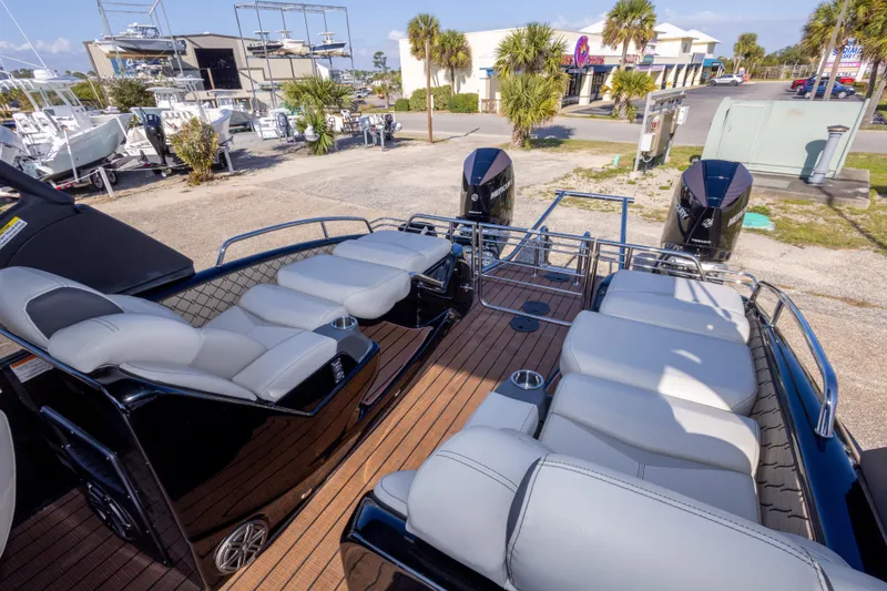 Slide: The Image of 2024 Manitou 25 LX SRW Dual Engine boat with luxurious seating and sleek design. - 24