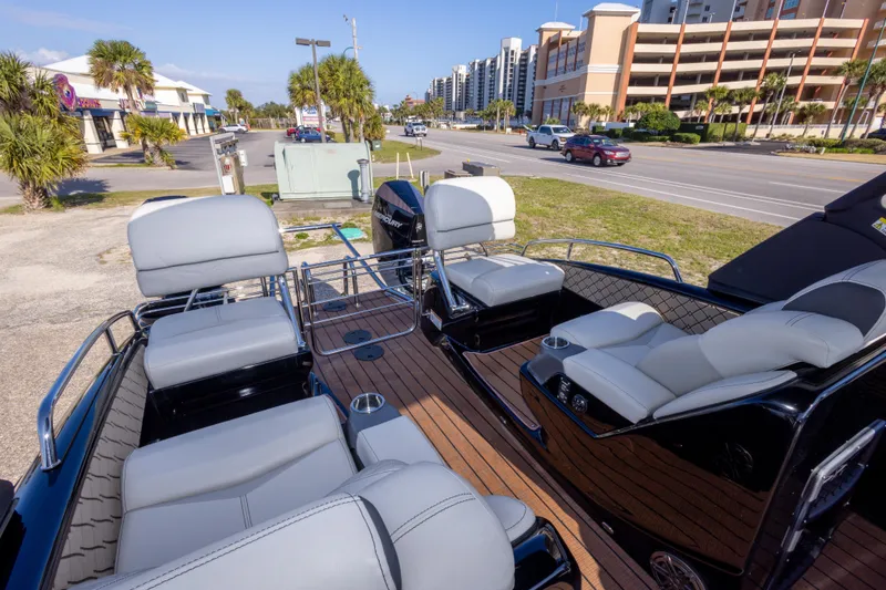 Slide: The Image of 2024 Manitou 25 LX SRW Dual Engine boat with luxurious seating and modern design. - 25