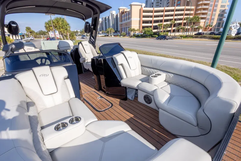 Slide: The Image of 2024 Manitou 25 LX SRW Dual Engine boat with luxurious seating and modern design. - 36