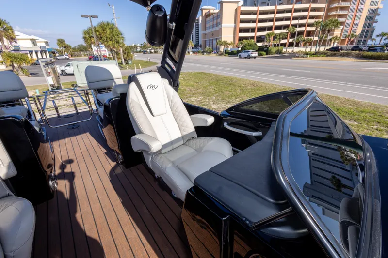 Slide: The Image of 2024 Manitou 25 LX SRW Dual Engine boat interior with luxurious seating and sleek design. - 39