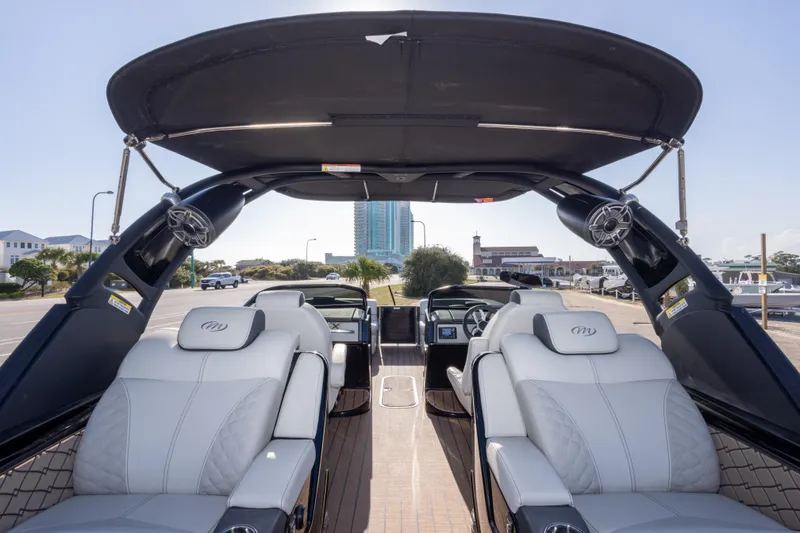 Slide: The Image of 2024 Manitou 25 LX SRW Dual Engine boat interior with luxurious seating and modern design. - 44