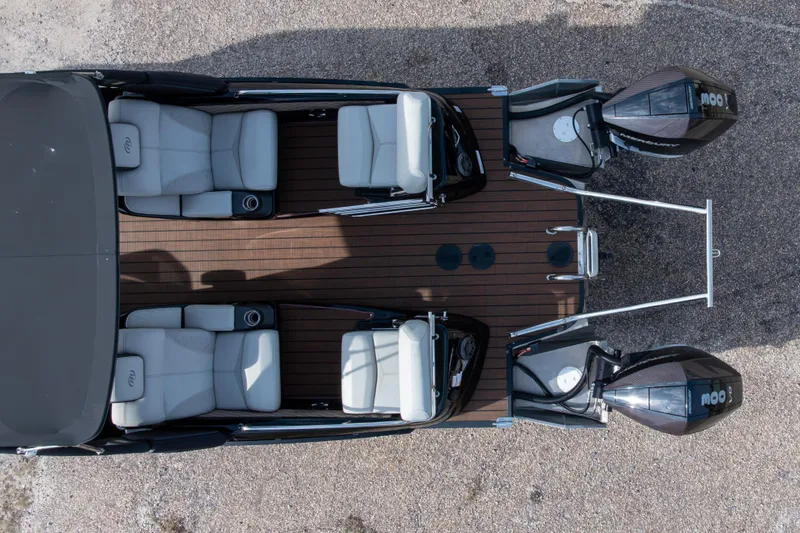 Slide: The Image of 2024 Manitou 25 LX SRW Dual Engine boat with luxurious seating and dual outboard motors. - 6