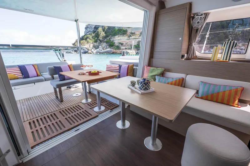 Slide: The Image of Luxurious interior of 2025 Lagoon 38 catamaran with colorful cushions and scenic ocean view. - 45