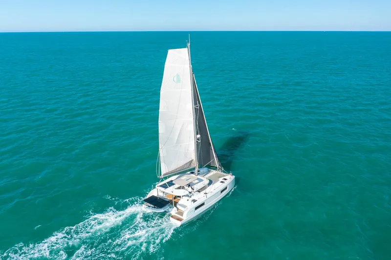 Slide: The Image of 2025 Lagoon 38 catamaran sailing on open turquoise sea. - 77