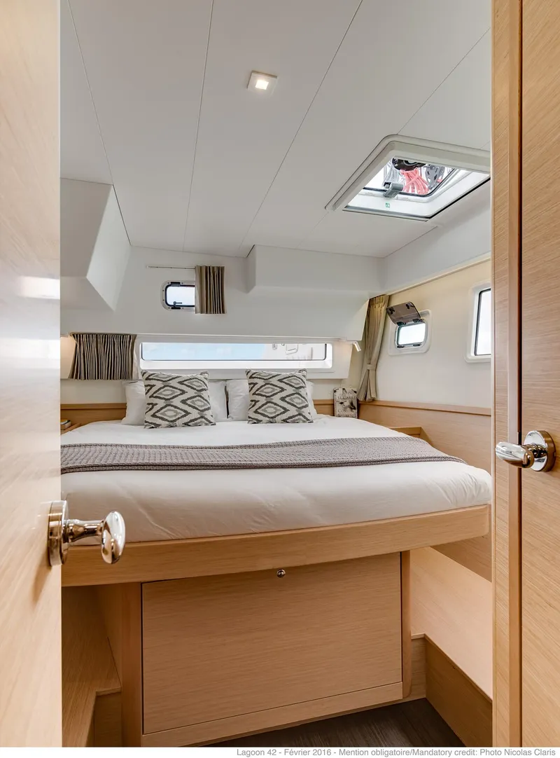 Slide: The Image of Luxurious cabin interior of 2025 Lagoon 42 Millenium yacht, featuring a cozy bed and modern design. - 15