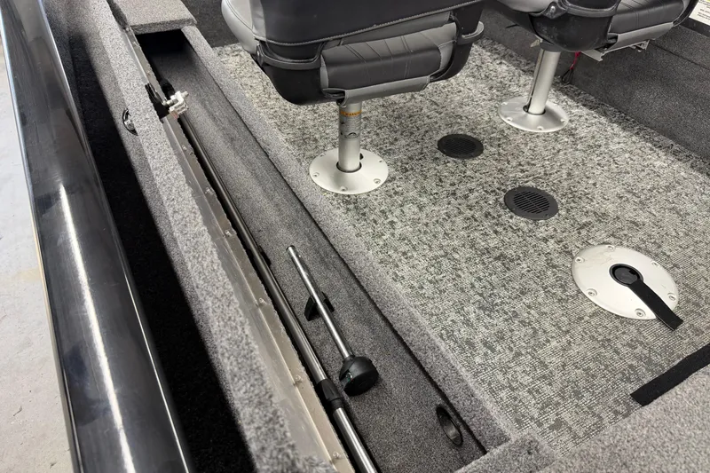 Slide: The Image of 2025 Tracker Super Guide V-16 SC interior with storage compartment and seating. - 14