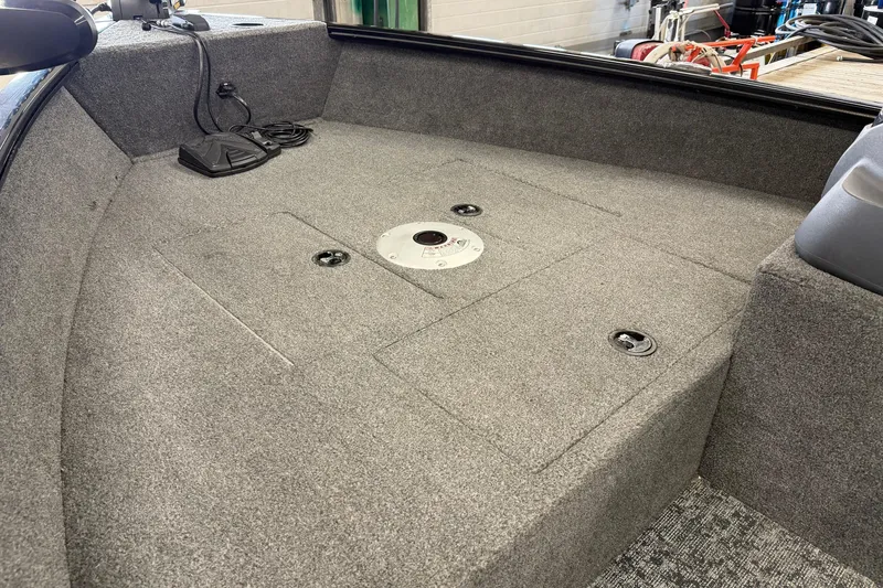 Slide: The Image of 2025 Tracker Super Guide V-16 SC boat interior with carpeted deck and storage compartments. - 15
