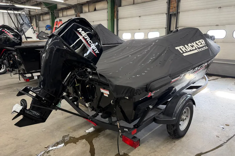 Slide: The Image of 2025 Tracker Super Guide V-16 SC boat with Mercury engine, covered and on trailer. - 5