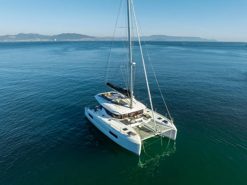 Slide: The Image of 2025 Lagoon 43 catamaran sailing on calm blue ocean waters. - 0