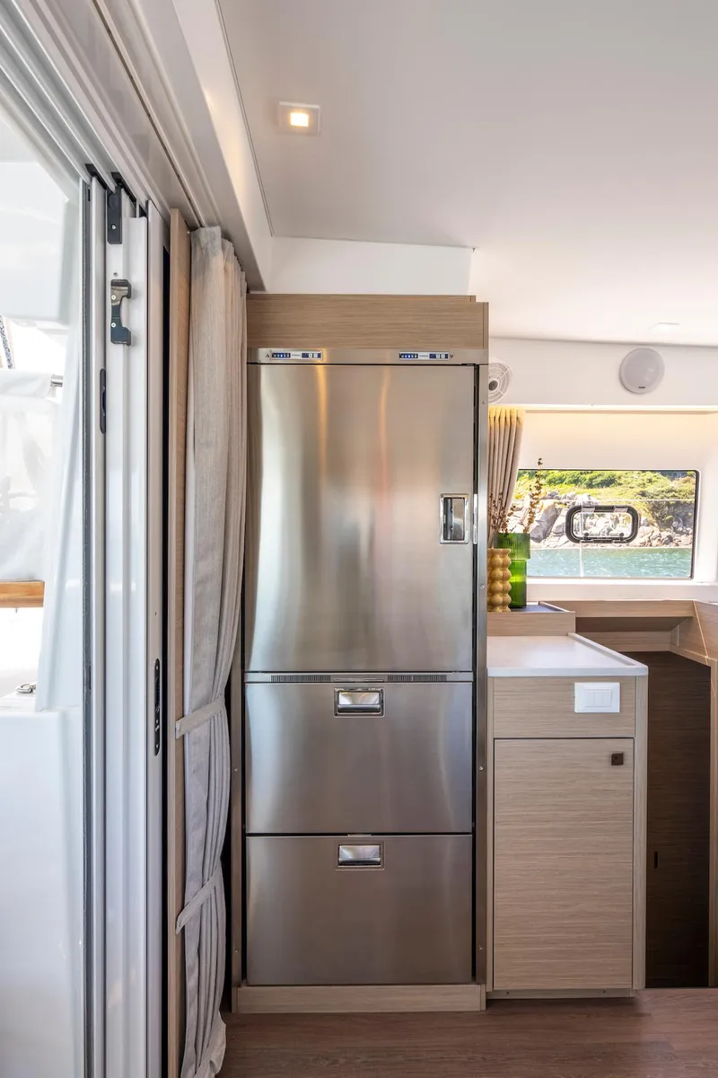 Slide: The Image of Modern kitchen area in a 2025 Lagoon 43 yacht, featuring sleek stainless steel appliances. - 19
