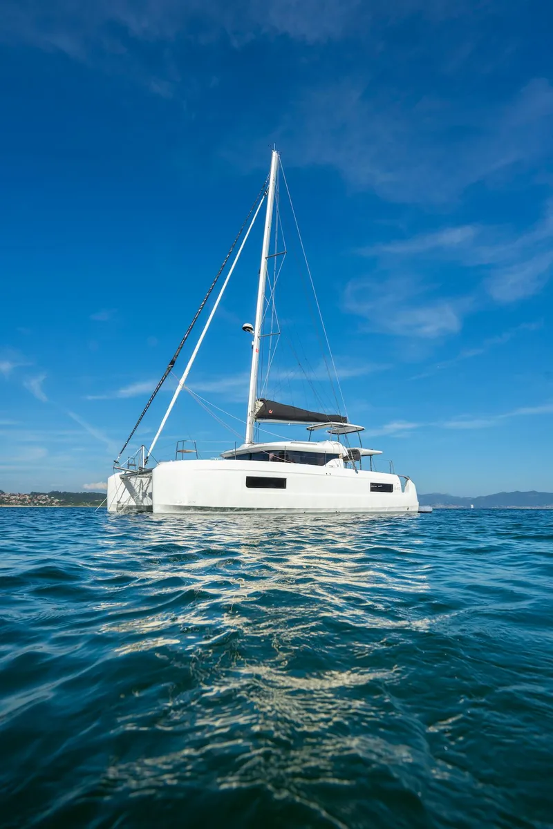 Slide: The Image of 2025 Lagoon 43 catamaran sailing on calm blue waters under clear skies. - 47