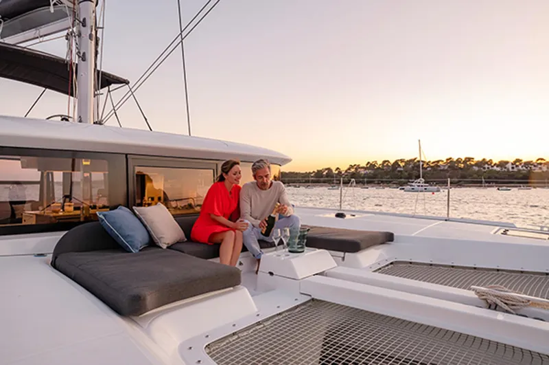 Slide: The Image of Couple relaxing on Lagoon 46 ICONIC yacht at sunset, 2025 model. - 7
