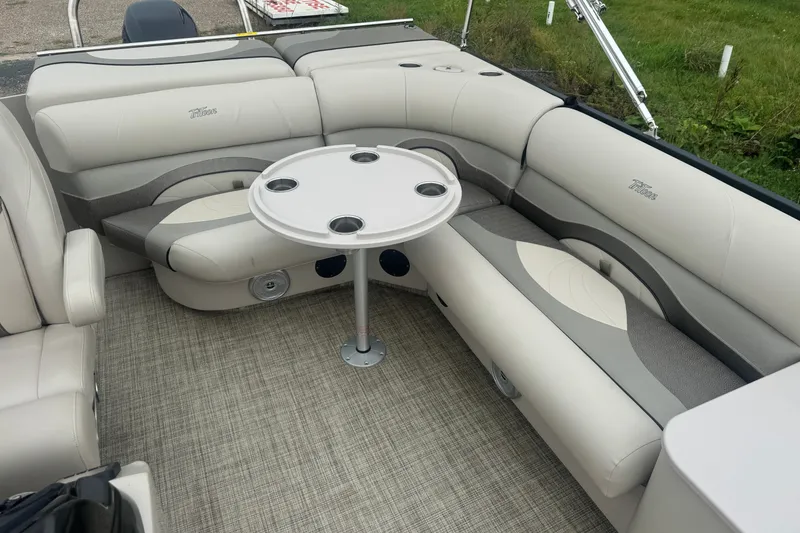 Slide: The Image of 2017 JC 23 Neptoon TT Sport boat interior with plush seating and round table. - 11