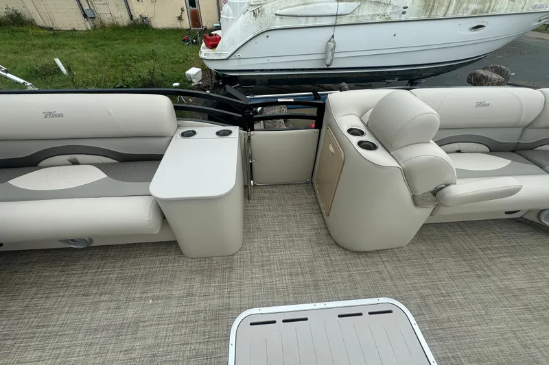 Slide: The Image of 2017 JC 23 Neptoon TT Sport boat interior with beige seating and cup holders. - 15