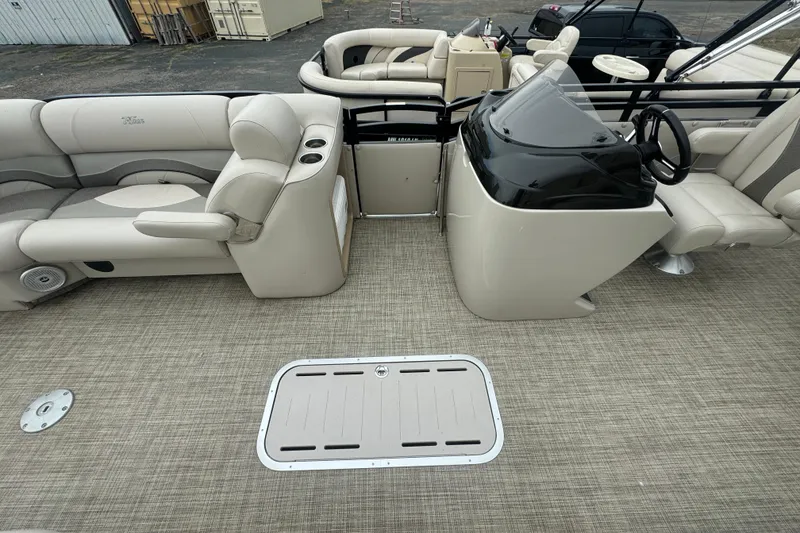 Slide: The Image of 2017 JC 23 Neptoon TT Sport pontoon boat interior with beige seating and helm. - 17