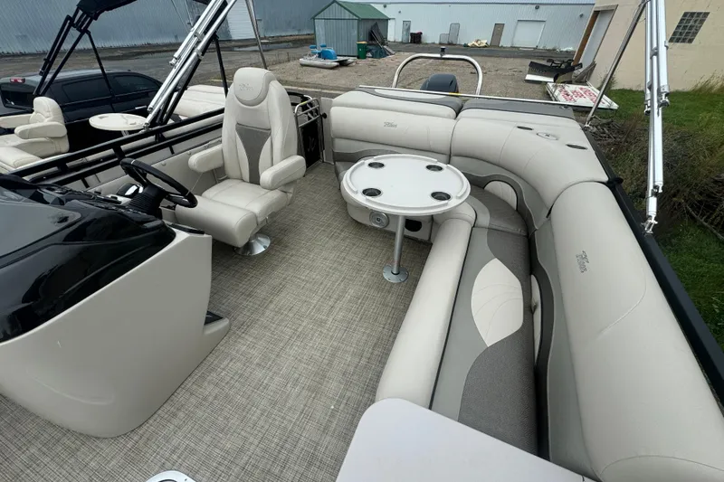 Slide: The Image of 2017 JC 23 Neptoon TT Sport pontoon boat interior with plush seating and table. - 18