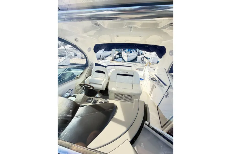 Slide: The Image of Interior view of a 2008 Sea Ray 40 Sundancer yacht, showcasing helm and seating area. - 11
