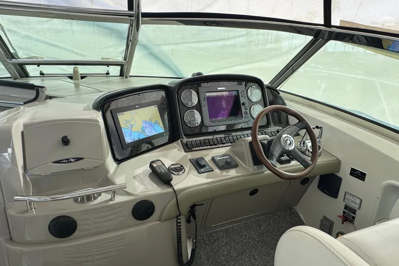 Slide: The Image of Helm of 2008 Sea Ray 40 Sundancer with navigation screens and steering wheel. - 13
