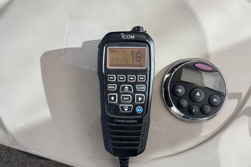 Slide: The Image of ICOM radio and control panel on 2008 Sea Ray 40 Sundancer. - 19