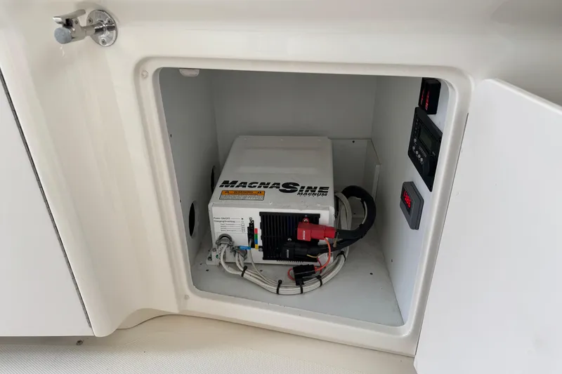 Slide: The Image of Electrical compartment of 2008 Sea Ray 40 Sundancer with Magnum inverter and control panel. - 29